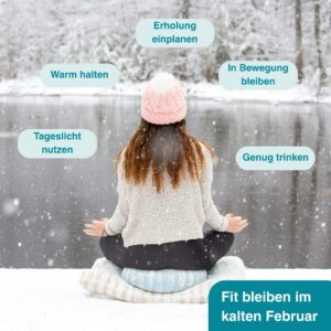 Eine Frau sitzt im Winter an einem gefrorenen See und meditiert.